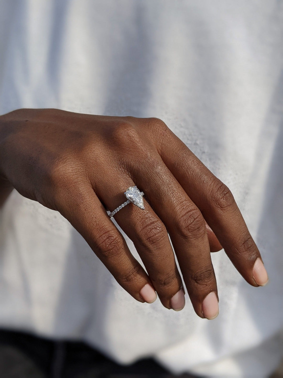 Pear pave engagement ring viewed from the side
