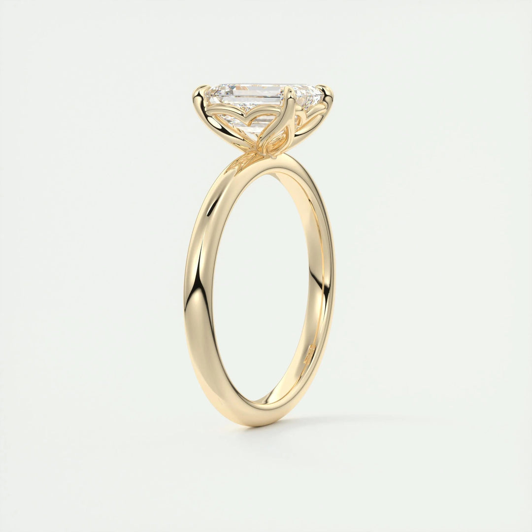 Lifestyle shot of emerald solitaire diamond ring on hand
