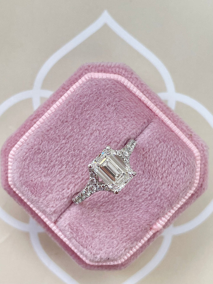 Lifestyle shot of emerald split shank diamond ring on hand