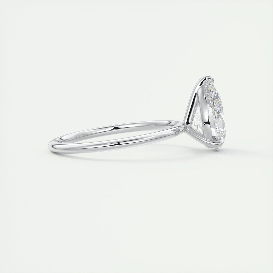 Pear solitaire engagement ring close-up showing F-/VS1 diamond clarity