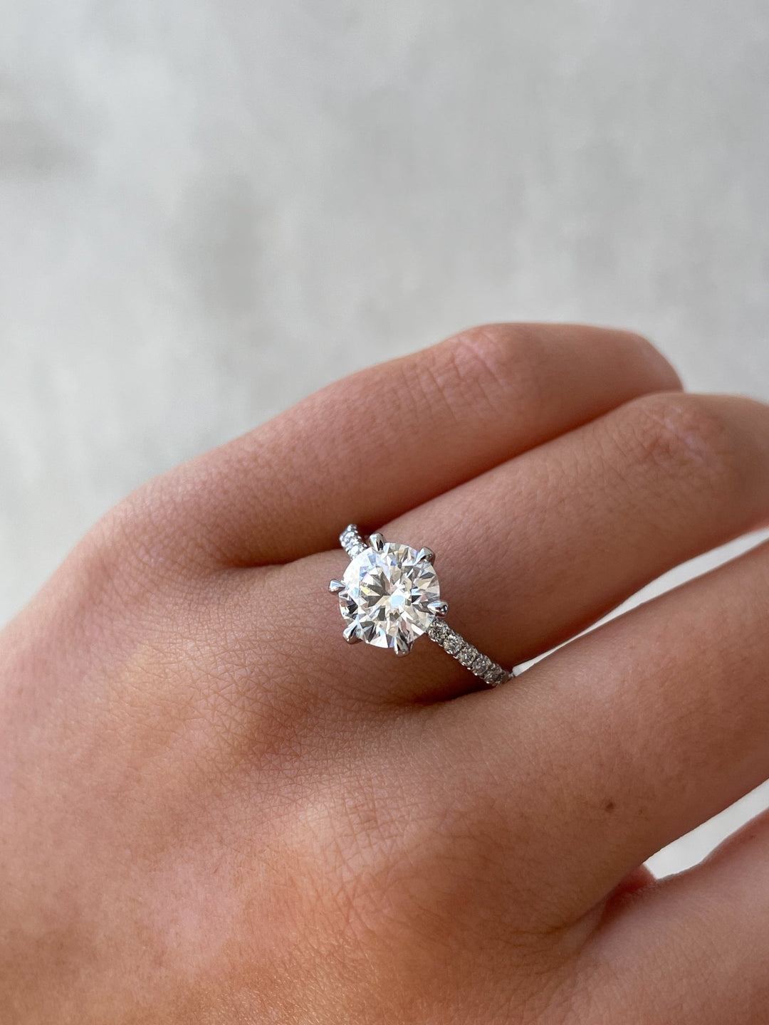 Round cut diamond ring worn on hand