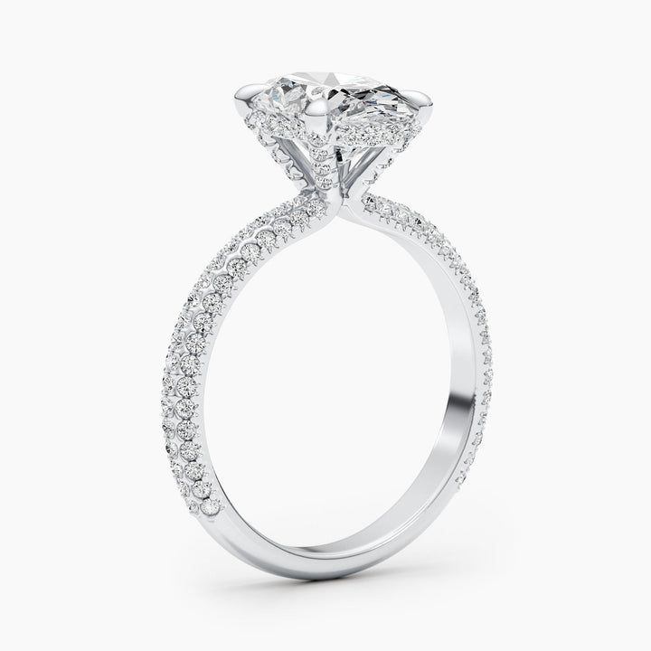 Oval hidden halo engagement ring photographed in natural light