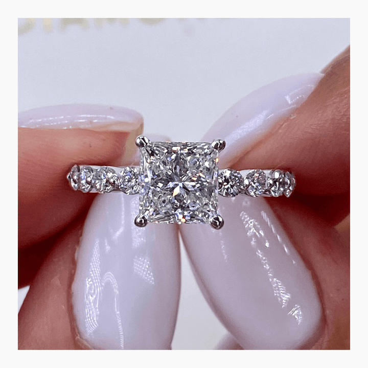 Macro shot of princess cut diamond facets in pave ring setting