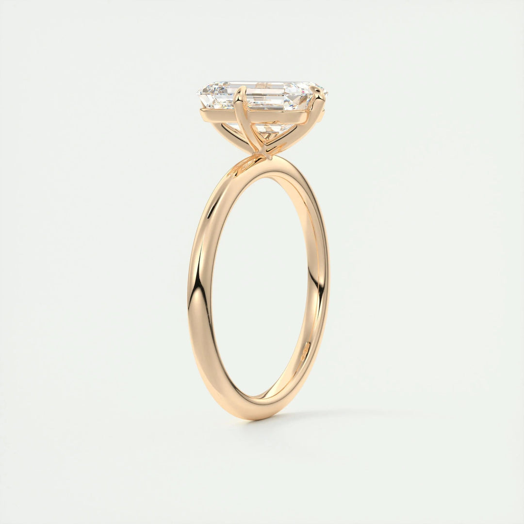 Emerald solitaire engagement ring viewed from the side