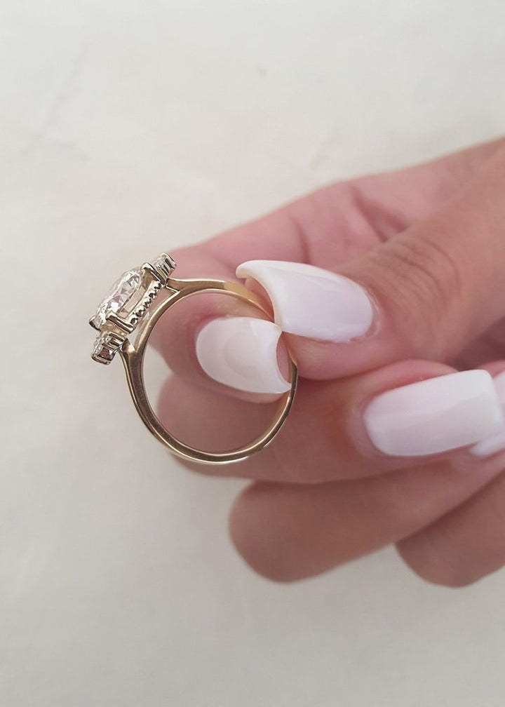 Lifestyle shot of round cluster diamond ring on hand