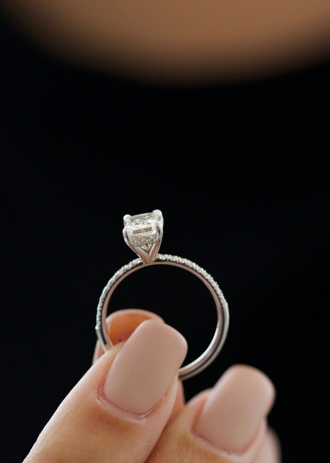 Macro shot of radiant cut diamond facets in pave ring setting
