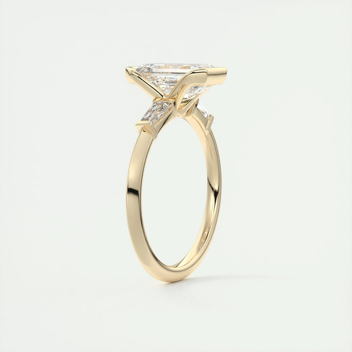 Macro shot of emerald cut diamond facets in three stone ring setting