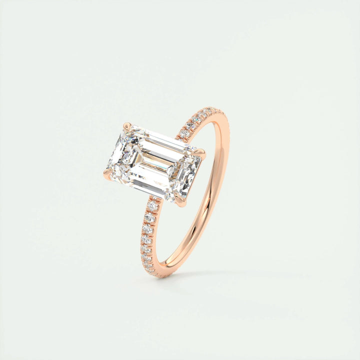 Macro shot of emerald cut diamond facets in pave ring setting