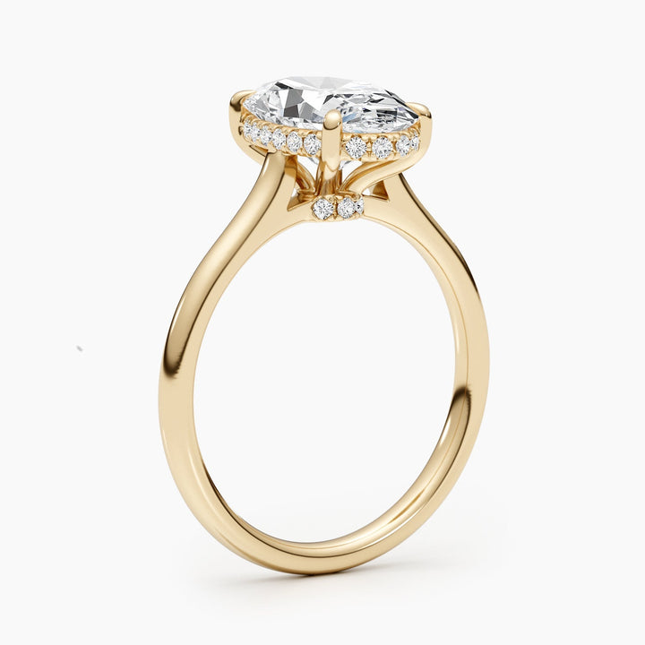 Oval hidden halo engagement ring photographed in natural light