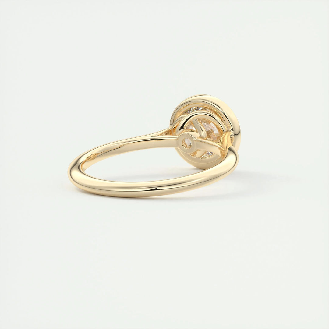 Close-up of round cut center diamond in bezel engagement ring