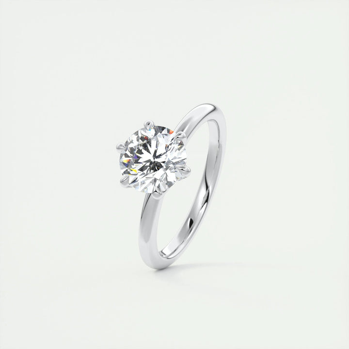 Round solitaire diamond ring displayed on jewelry stand
