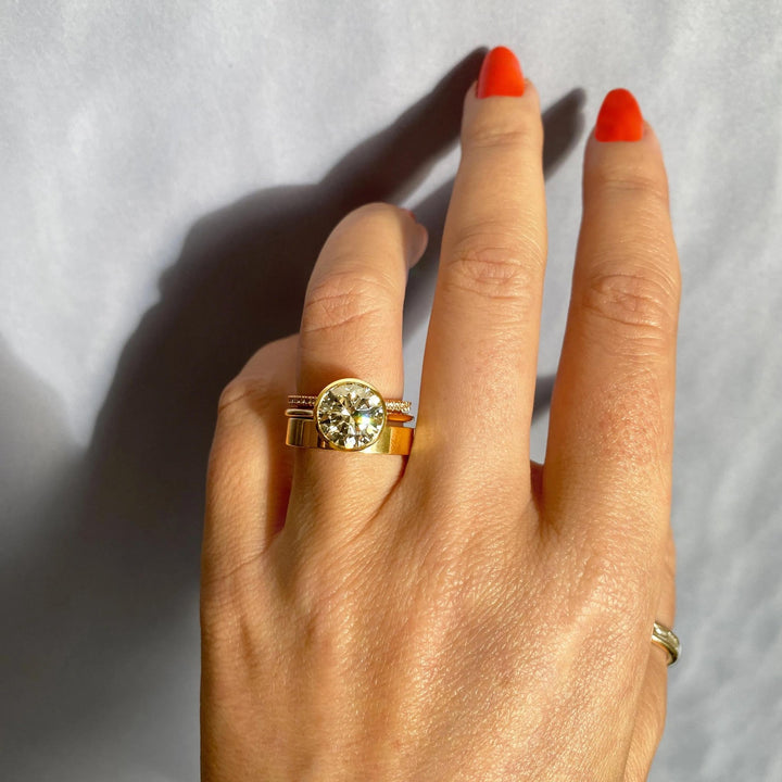 Round bezel lab grown diamond ring fitted on finger