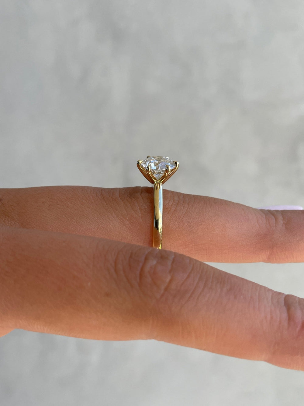 Certified round cut diamond featured in solitaire engagement ring