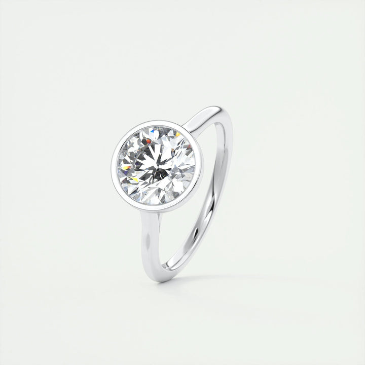 Round bezel diamond ring displayed on jewelry stand