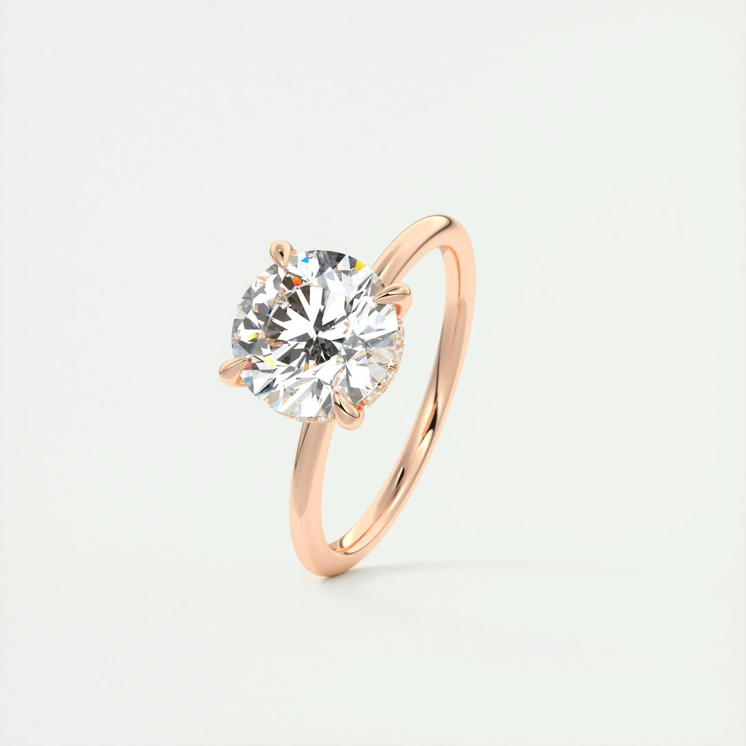 Round hidden halo engagement ring offered in gold and platinum