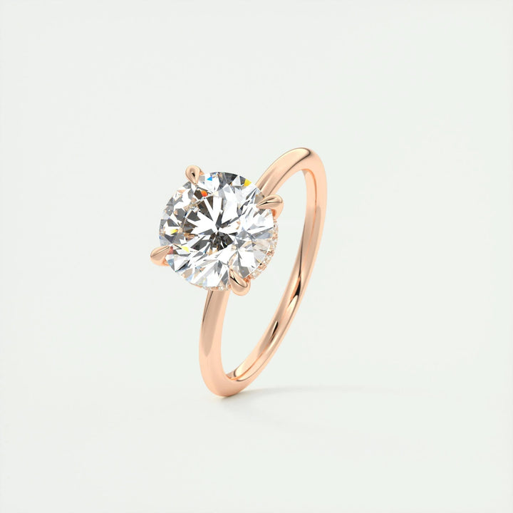 Round hidden halo engagement ring offered in gold and platinum