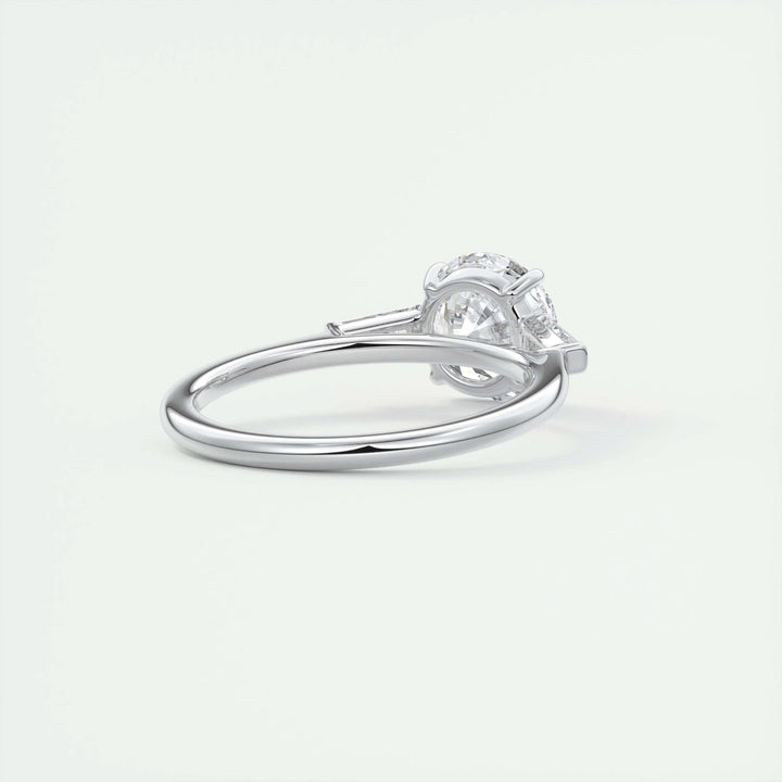 Angled view of round cut diamond in three stone setting