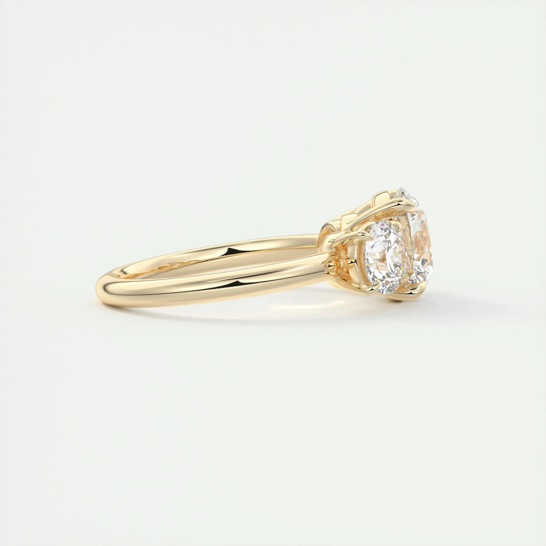 Round three stone engagement ring finished in polished solid gold