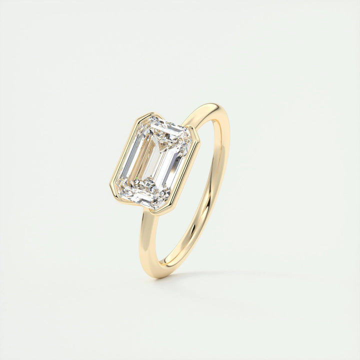 Emerald solitaire engagement ring photographed in natural light