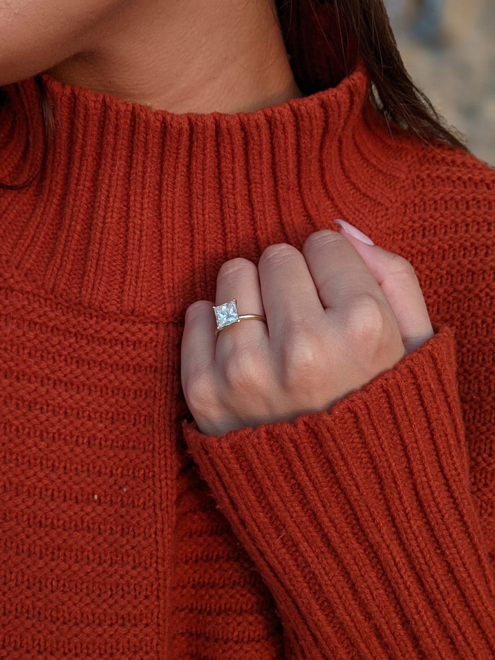 Princess cut solitaire engagement ring shown in real-life wear