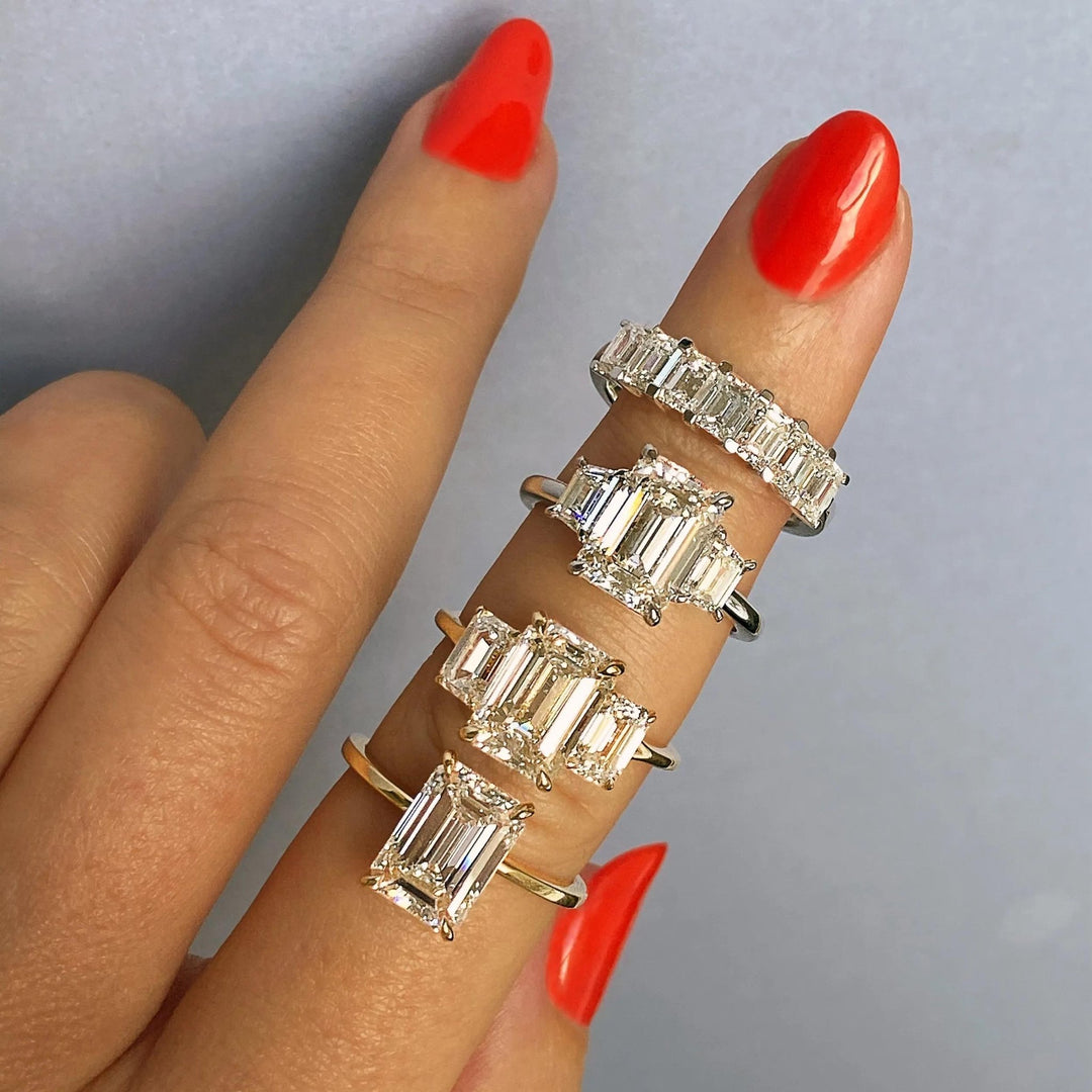 Emerald three stone diamond ring presented in signature gift packaging