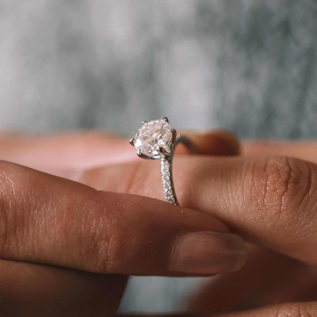 Profile view of round cut pave engagement ring band