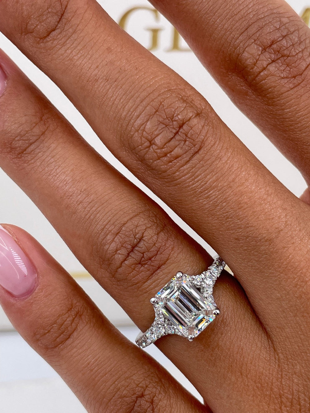 Emerald split shank engagement ring viewed from the side