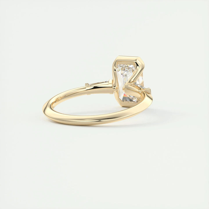 Close-up of emerald cut center diamond in three stone engagement ring