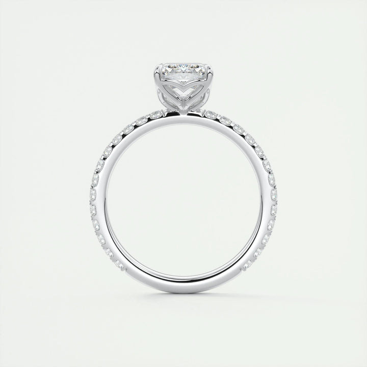 Macro shot of emerald cut diamond facets in pave ring setting