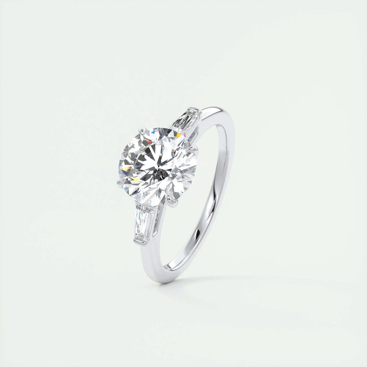 Round three stone diamond ring displayed on jewelry stand