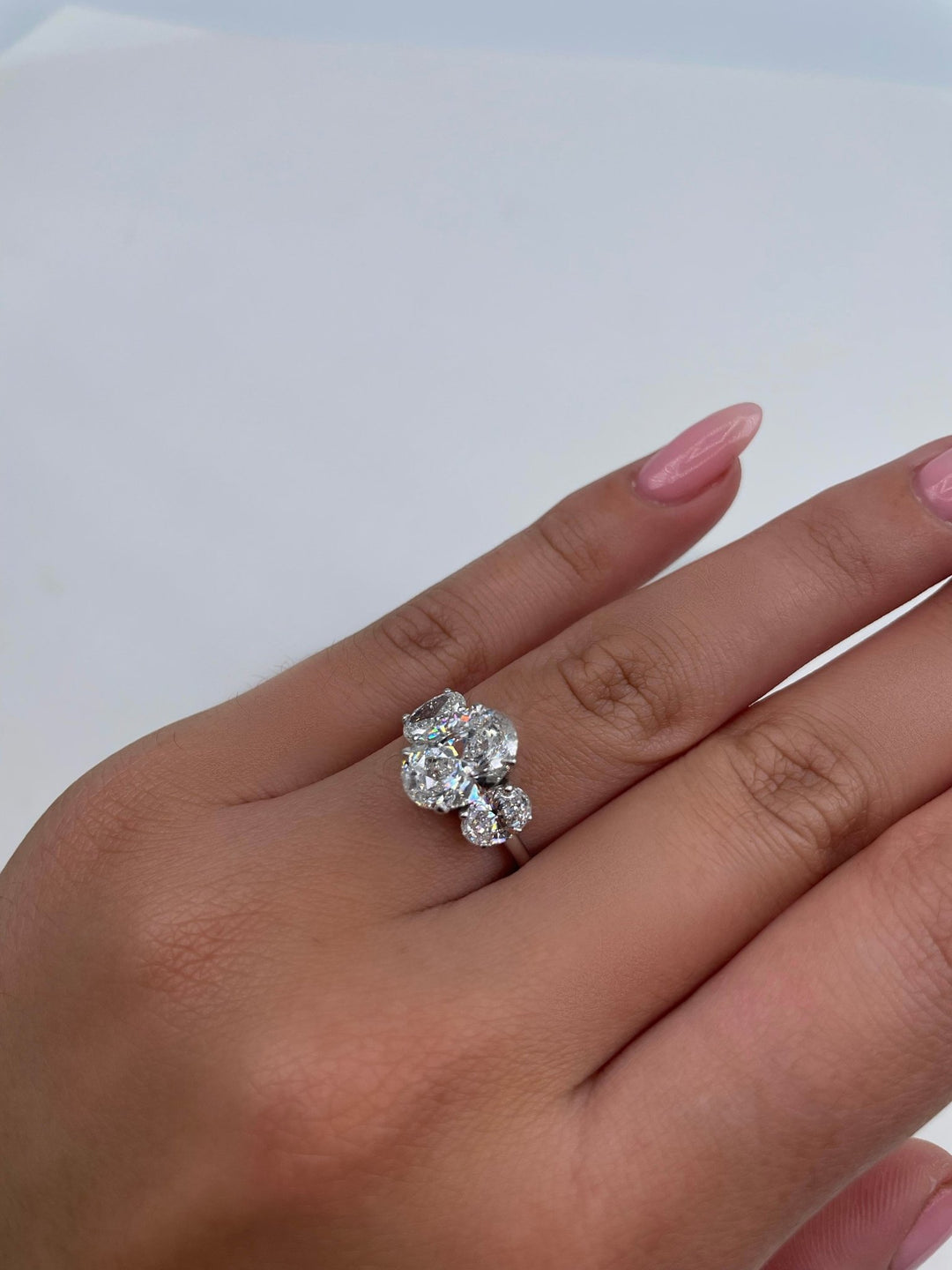 Angled view of oval cut diamond in three stone setting