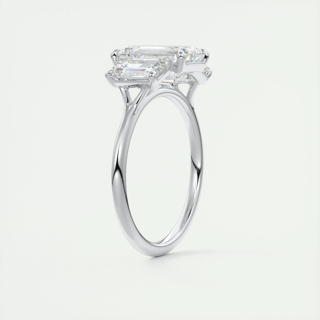 Close-up of emerald cut center diamond in three stone engagement ring