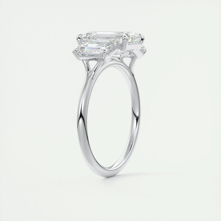 Close-up of emerald cut center diamond in three stone engagement ring