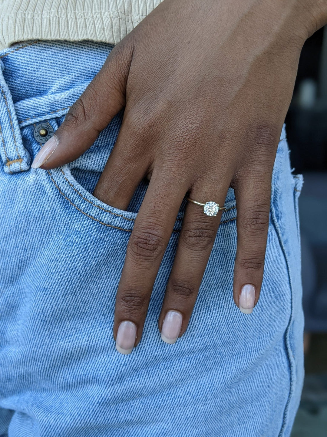 Round hidden halo engagement ring offered in gold and platinum