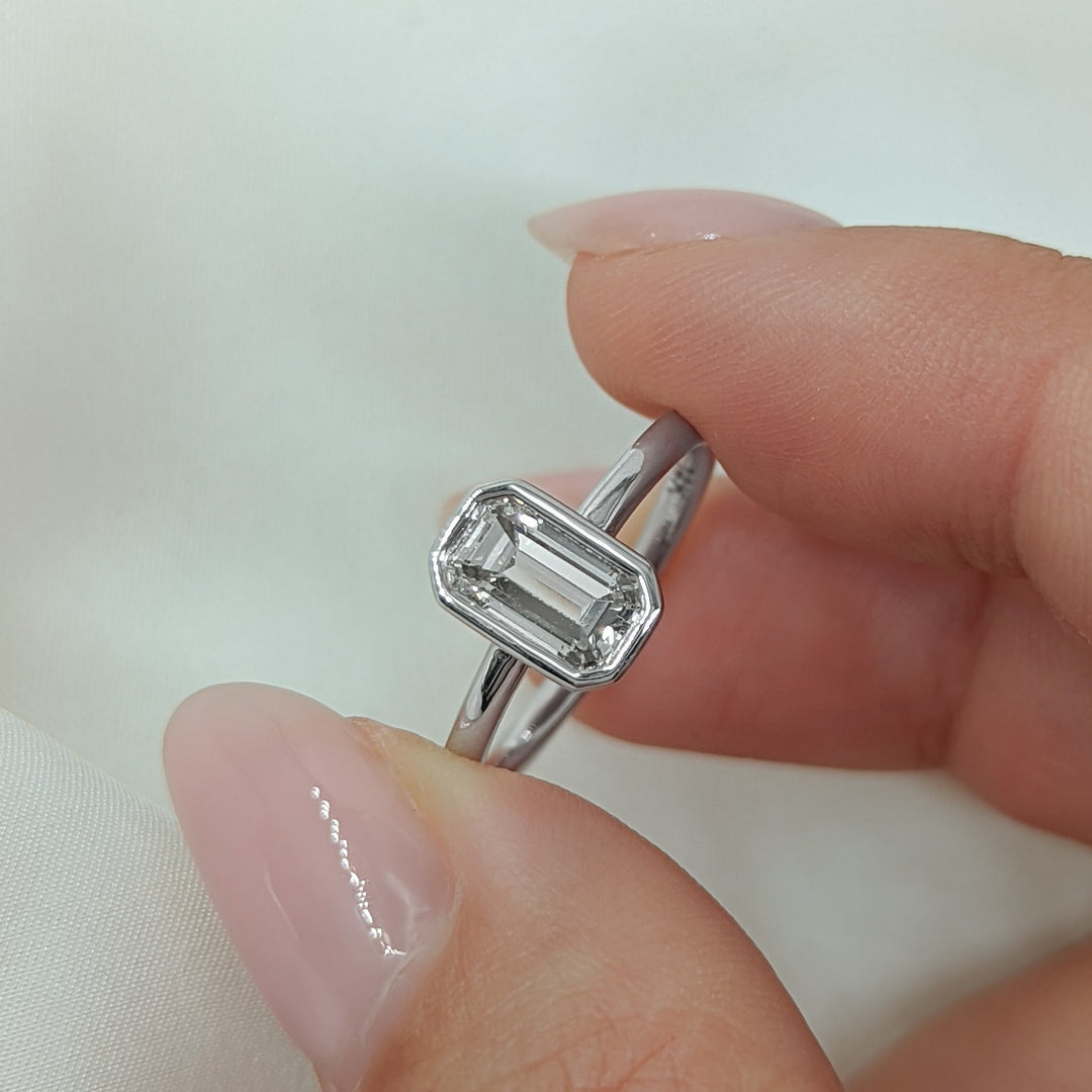 Emerald bezel lab grown diamond ring fitted on finger