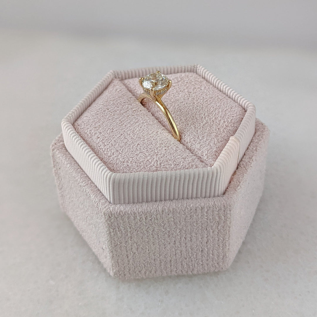 Round hidden halo diamond ring presented in signature gift packaging